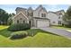 Charming two-story home featuring stone and gray siding, a two car garage, and a well maintained lawn at 2133 Creekview Trl, Decatur, GA 30035