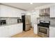 Well-equipped kitchen features stainless steel appliances, white cabinetry and granite countertops at 2133 Creekview Trl, Decatur, GA 30035