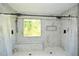 Modern shower features a rainfall shower head, bench seating, and a window for natural light at 2133 Creekview Trl, Decatur, GA 30035