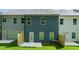 Back view of new townhomes with fenced-in patios and green yards at 340 Sinclair Ct, Mcdonough, GA 30253