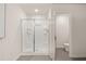 Clean and well-lit bathroom featuring a shower with glass doors and tiled flooring at 340 Sinclair Ct, Mcdonough, GA 30253