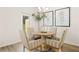 Bright dining area with a round table and seating for four, complemented by contemporary decor and natural light at 340 Sinclair Ct, Mcdonough, GA 30253