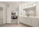 Bright bathroom with double vanity and sinks, with an open doorway to the main bedroom at 340 Sinclair Ct, Mcdonough, GA 30253