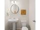 Elegant powder room featuring a pedestal sink, modern fixtures, and stylish decorations at 340 Sinclair Ct, Mcdonough, GA 30253