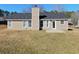 The home's backyard, featuring a patio and views of the surrounding greenery at 3577 N Winds N Trl, Douglasville, GA 30135