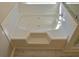 A bathroom featuring a soaking tub with integral steps and tile surround at 3577 N Winds N Trl, Douglasville, GA 30135