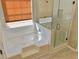 A bathroom showcasing a tub with tile surround and separate glass-enclosed shower at 3577 N Winds N Trl, Douglasville, GA 30135