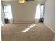 Spacious bedroom with plush carpet, neutral walls, and ample natural light from the windows at 3577 N Winds N Trl, Douglasville, GA 30135