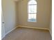 A cozy bedroom with neutral carpet and a large window for ample natural light at 3577 N Winds N Trl, Douglasville, GA 30135