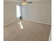 Large carpeted bedroom featuring neutral walls, ceiling fan and window to provide natural light at 3577 N Winds N Trl, Douglasville, GA 30135