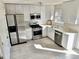 Well-lit kitchen with stainless steel appliances, white cabinetry, and sleek countertops at 3577 N Winds N Trl, Douglasville, GA 30135