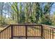 A wooden deck looks out onto a large, green, tree filled backyard at 3761 Turner Heights Dr, Decatur, GA 30032