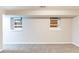 Basement with neutral walls, carpeted flooring, and two windows at 3761 Turner Heights Dr, Decatur, GA 30032
