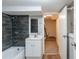 A renovated bathroom with a shower, tub, and stylish gray tile at 3761 Turner Heights Dr, Decatur, GA 30032