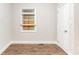 Cozy bedroom featuring a window, door, and newly installed laminate flooring at 3761 Turner Heights Dr, Decatur, GA 30032