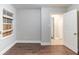 View of a neutral bedroom with an open door, featuring wood-look floors at 3761 Turner Heights Dr, Decatur, GA 30032
