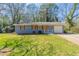 Ranch style home with a gray painted brick exterior and a well maintained front lawn at 3761 Turner Heights Dr, Decatur, GA 30032
