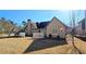 View of the backyard with a well maintained lawn, landscaping, and home exterior at 4875 Gladstone Pkwy, Suwanee, GA 30024