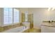 Elegant bathroom featuring a soaking tub, glass-enclosed shower, and granite vanity at 4875 Gladstone Pkwy, Suwanee, GA 30024