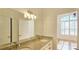 Bathroom featuring a double granite vanity, large mirror, and natural light from the window at 4875 Gladstone Pkwy, Suwanee, GA 30024