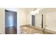 Bright bathroom features a double granite vanity, generous mirror, and elegant lighting at 4875 Gladstone Pkwy, Suwanee, GA 30024