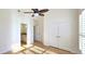 Bedroom with high ceilings, ceiling fan, closet, hardwood floors, and natural light at 4875 Gladstone Pkwy, Suwanee, GA 30024