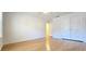 Bright bedroom featuring hardwood floors, neutral walls, and large closet with double doors at 4875 Gladstone Pkwy, Suwanee, GA 30024