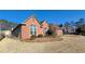Expansive yard surrounds home with mature trees, well-maintained landscaping and brick exterior at 4875 Gladstone Pkwy, Suwanee, GA 30024