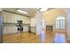 Open-concept kitchen with view to living room and fireplace featuring granite counters and stainless appliances at 4875 Gladstone Pkwy, Suwanee, GA 30024