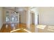 Spacious living room featuring hardwood floors, high ceilings, and natural light at 4875 Gladstone Pkwy, Suwanee, GA 30024