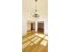 Elegant living room with hardwood floors, wainscoting, and decorative lighting fixture at 4875 Gladstone Pkwy, Suwanee, GA 30024