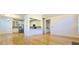 Open-concept living and dining room boasts hardwood floors and a view of the modern kitchen at 4875 Gladstone Pkwy, Suwanee, GA 30024