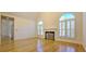 Bright living area showcasing a fireplace, hardwood floors, and arched windows at 4875 Gladstone Pkwy, Suwanee, GA 30024