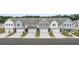 A street view showcases a row of attractive townhomes with well-maintained landscaping and inviting curb appeal at 541 Tuskegee St # 49, Mcdonough, GA 30253