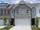 Charming townhome featuring a brick facade, pristine landscaping, and an attached two-car garage at 549 Tuskegee St # 51, Mcdonough, GA 30253