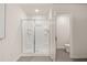 Bathroom featuring a glass enclosed shower and separate toilet area at 549 Tuskegee St, Mcdonough, GA 30253