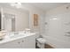 Bathroom featuring a single sink vanity, toilet, and shower-tub combo at 549 Tuskegee St, Mcdonough, GA 30253