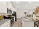 Bright, open kitchen featuring granite countertops, stainless steel appliances, and plenty of cabinet space at 549 Tuskegee St, Mcdonough, GA 30253