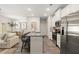 Open concept kitchen with stainless steel appliances and bar seating at 549 Tuskegee St, Mcdonough, GA 30253