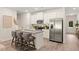 Modern kitchen with stainless steel appliances and a granite countertop island with barstool seating at 549 Tuskegee St, Mcdonough, GA 30253