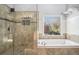 Bathroom features a walk-in shower and separate jacuzzi tub by a large window at 2785 Old Sewell Rd, Marietta, GA 30068