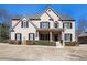 Charming two-story brick home featuring a manicured front yard, black shutters, and a covered front porch at 2785 Old Sewell Rd, Marietta, GA 30068