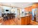 Bright kitchen with stainless steel appliances, granite island, and adjacent dining area at 2785 Old Sewell Rd, Marietta, GA 30068