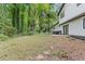 Large backyard of home with trees, patio and exterior of home with new deck at 353 Old Rosser Rd, Stone Mountain, GA 30087