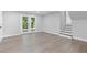 Basement area featuring hardwood floors, neutral paint, a staircase and French doors leading to the backyard at 353 Old Rosser Rd, Stone Mountain, GA 30087