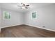 Neutral bedroom with hardwood floors, ceiling fan and two windows providing natural light at 353 Old Rosser Rd, Stone Mountain, GA 30087