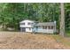 A charming two-story home with a combination gray garage, a vibrant turquoise front door, and white siding at 353 Old Rosser Rd, Stone Mountain, GA 30087