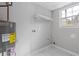 A functional laundry room features a water heater, shelf and a bright window for natural light at 353 Old Rosser Rd, Stone Mountain, GA 30087