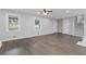 This is an open living room with hardwood floors, white walls, and large windows at 353 Old Rosser Rd, Stone Mountain, GA 30087