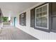 This is a covered porch featuring grey wood floors with a blue door at 353 Old Rosser Rd, Stone Mountain, GA 30087